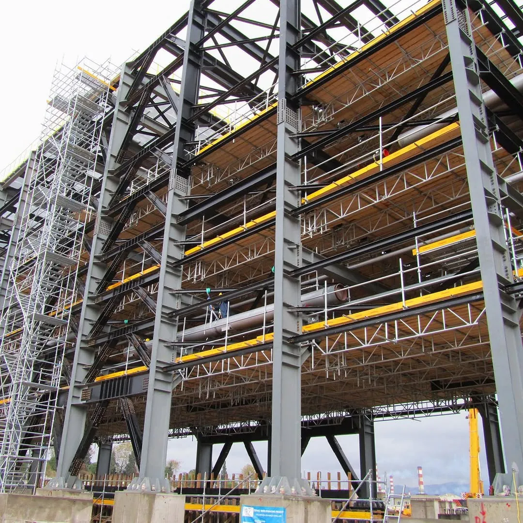 Structural steel frame under construction with scaffolding and access platforms